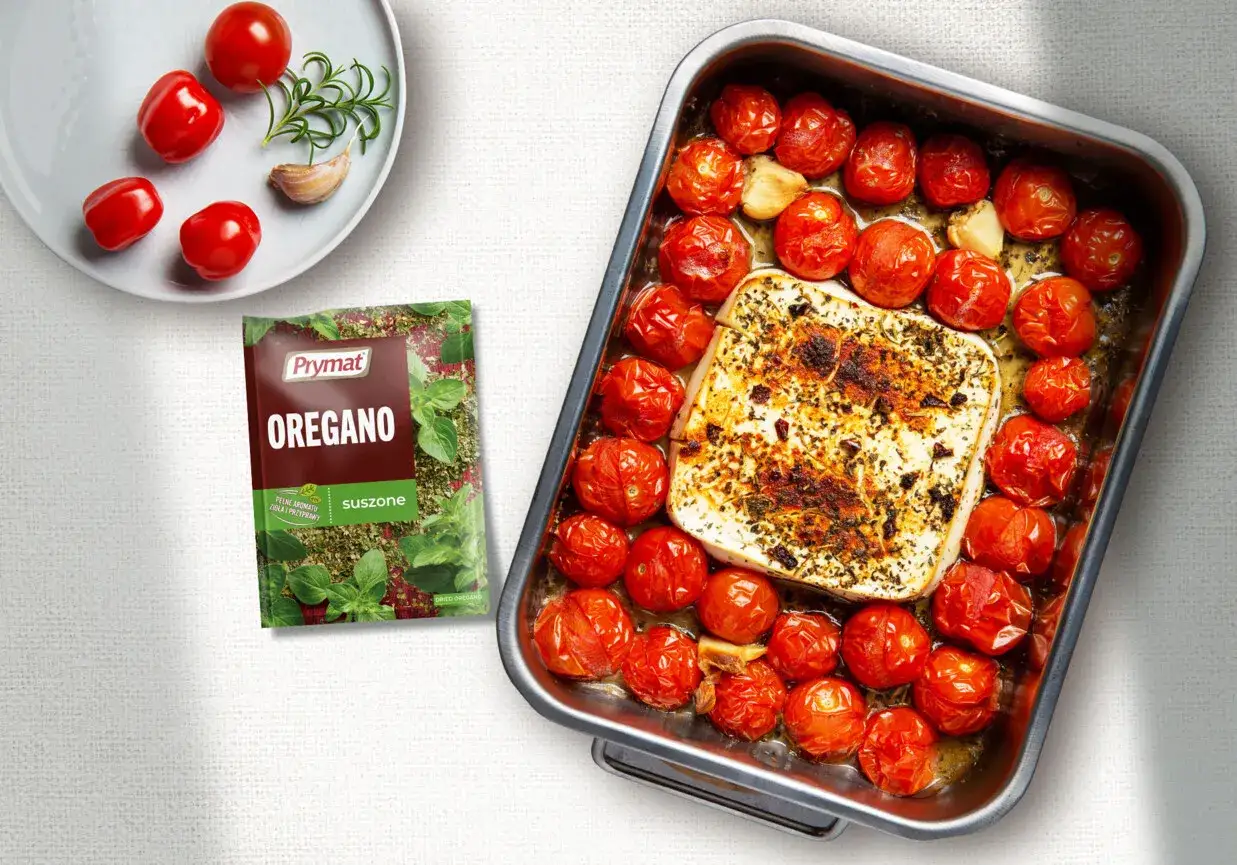 Pieczone pomidory z serem feta i czosnkiem, doprawione oregano. Pyszne i aromatyczne danie.